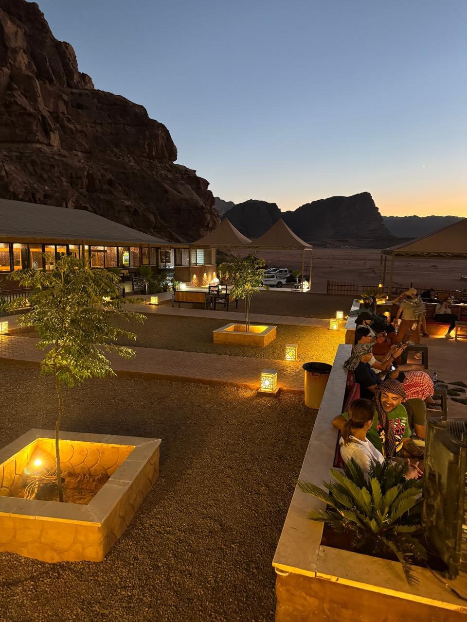 Lanterns lit along a desert camp terrace