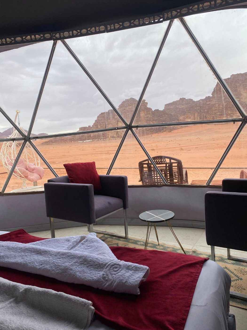 The terrace of a desert camp at dusk