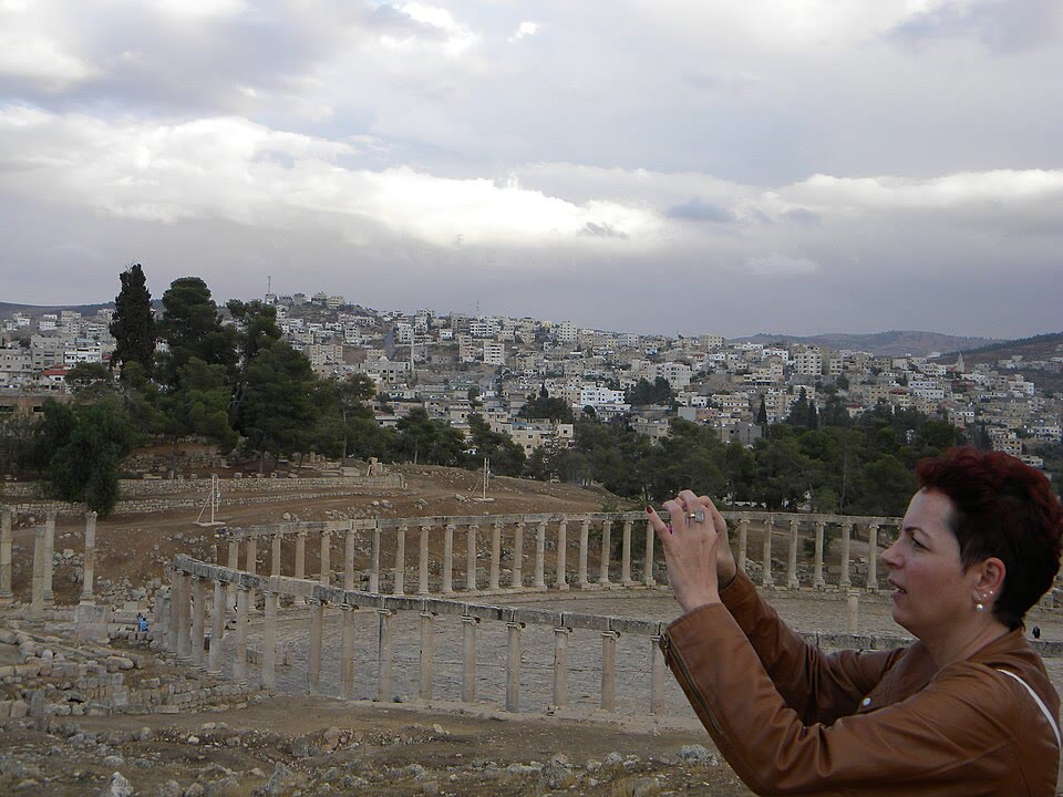 A traveller photographing the Oval Plaza at Jerash